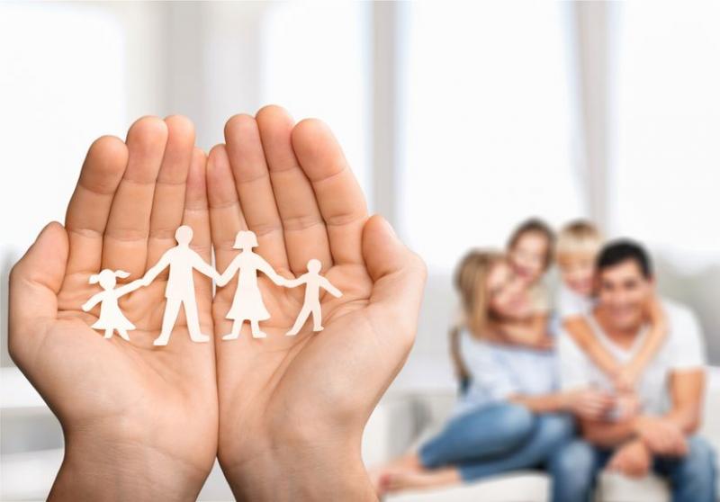 holding family cutout in hand